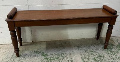 A late Victorian mahogany window seat on turned legs with cylindrical handles to ends - H47cm x