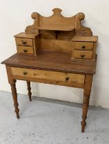 A pine desk with central drawer and drawers above with decorative shelf H 122cm x D 46 x W 90cm