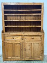 A Victorian pine dresser comprising of two drawers over a two door cupboard with a three shelf plate