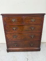 A flame mahogany two over three chest of drawers with one lower deep drawer and brass teardrop
